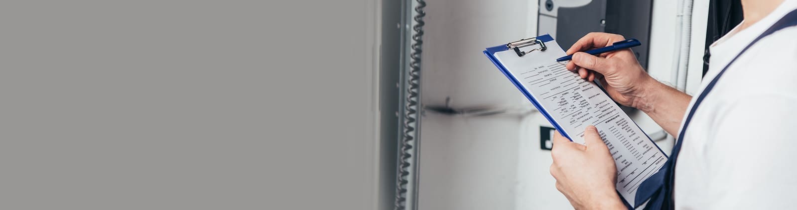 Hand Holding Pen Writing on Pad of Paper