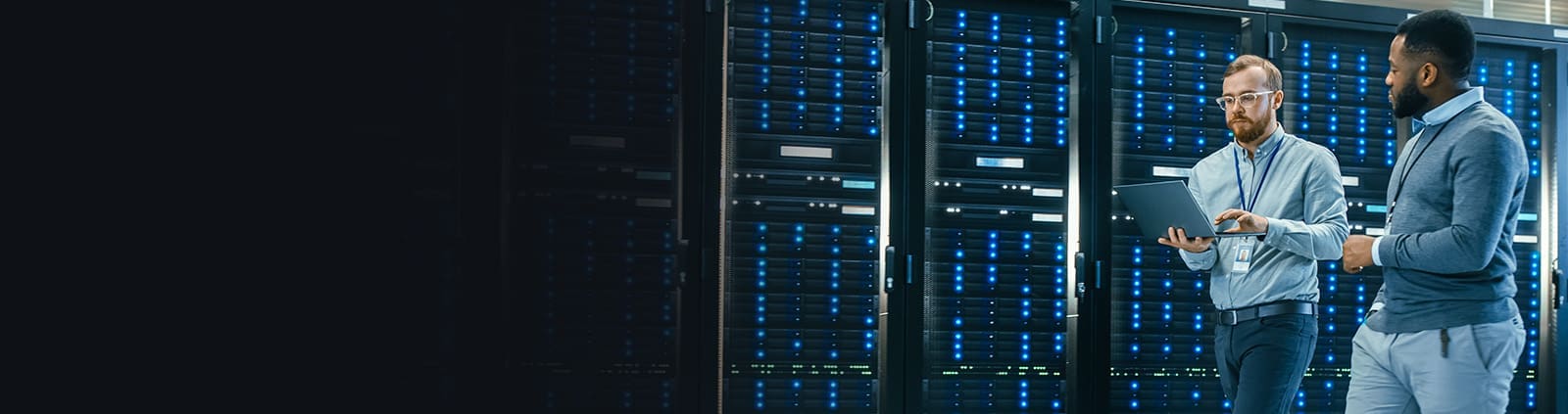 Two Professionals Walking with Laptop in Data Center