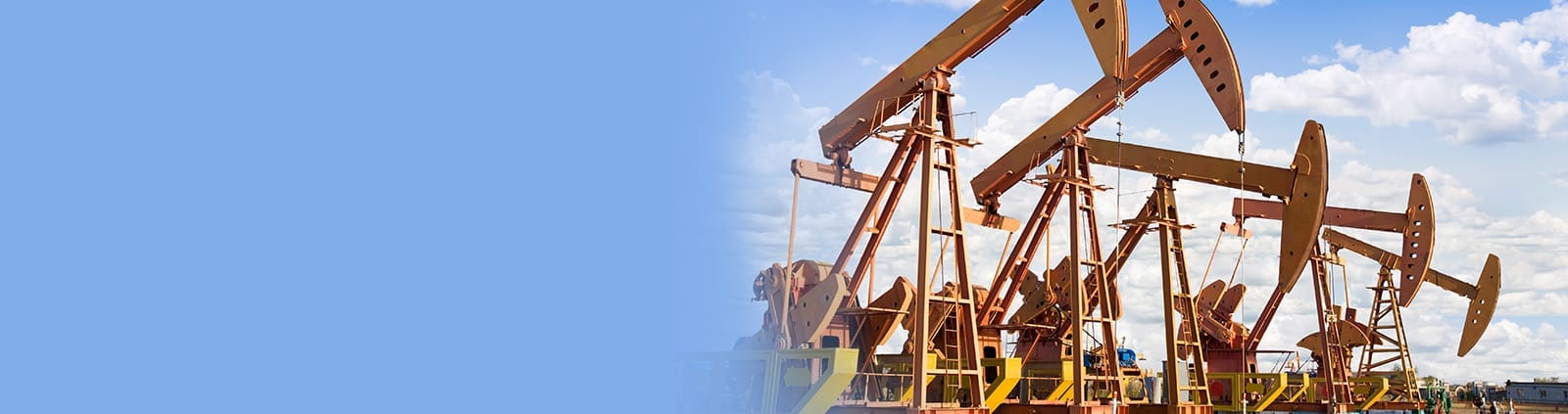 Yellow oil rigs in a line