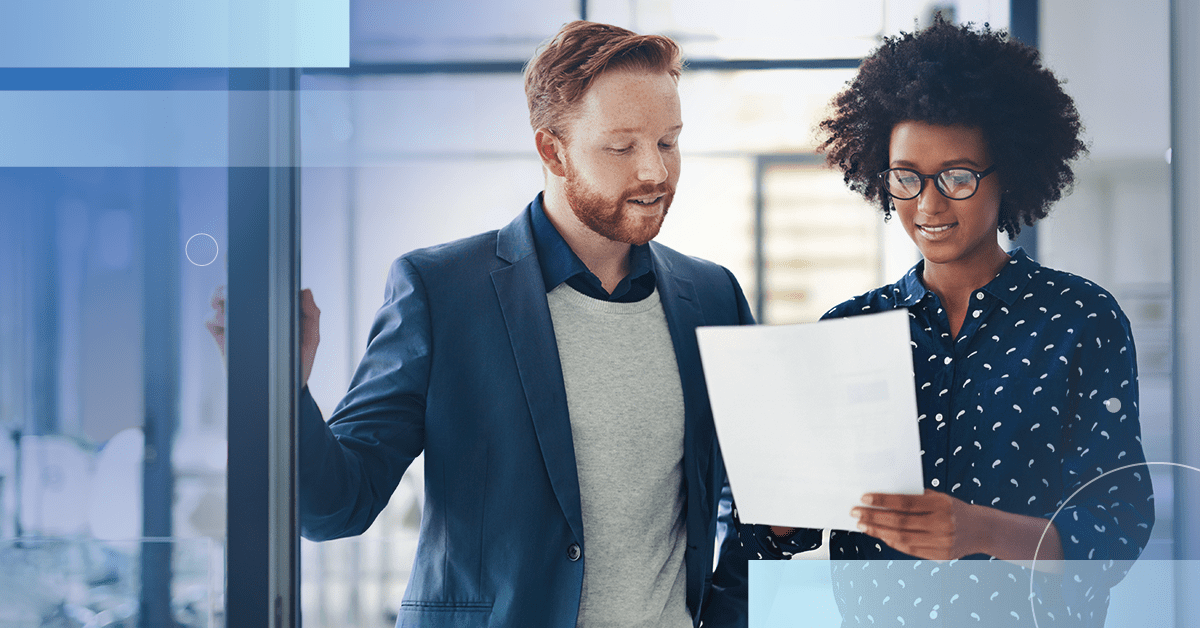 An image of a male and female professional reviewing a sheet