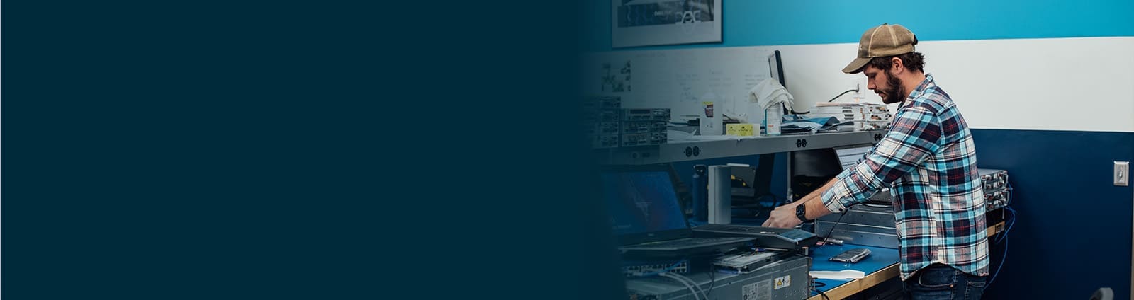 An image of a male engineer at a workstation testing parts