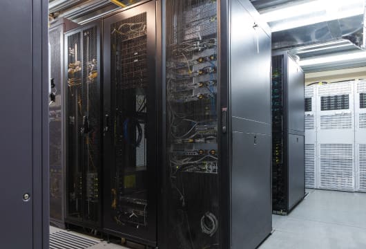 An image of row of equipment in a data center