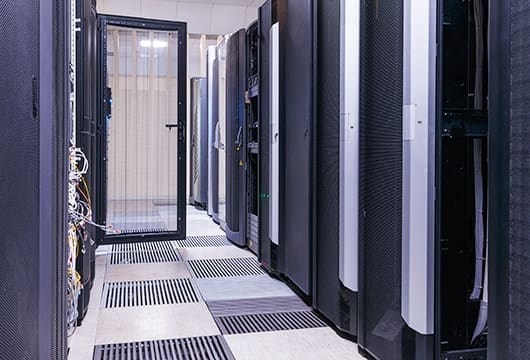 An image of a row of equipment racks one of the doors to the equipment rack is open