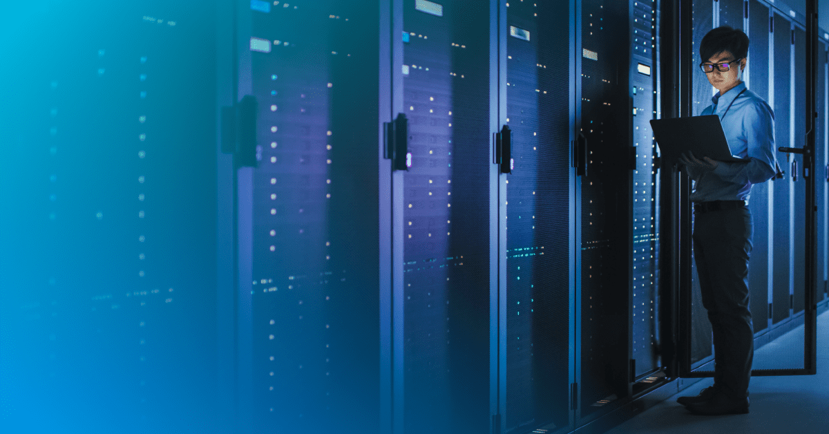 man in data center on a computer with a blue gradient overlay