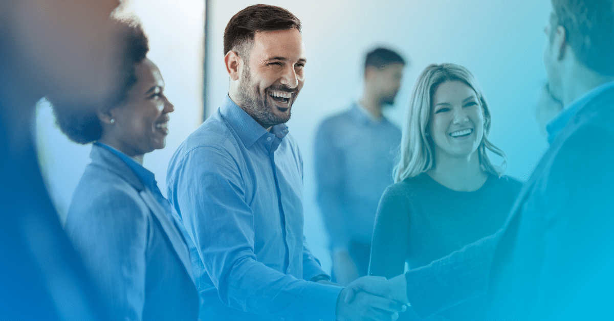 coworkers gathered smiling and shaking hands with an blue gradient overlay