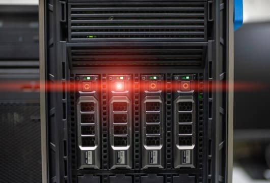 An image of the front of a server with a red light shining on
