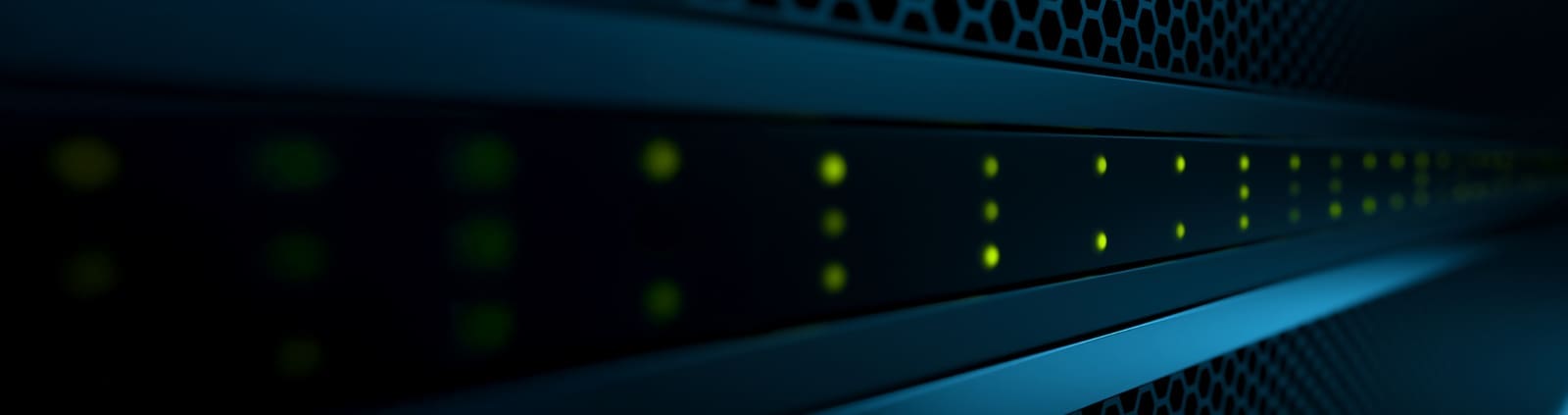 A close up image of green blinking lights on the front of a server