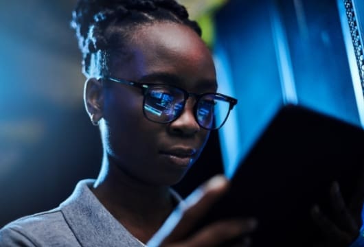 Female engineer wearing glasses holding a tablet