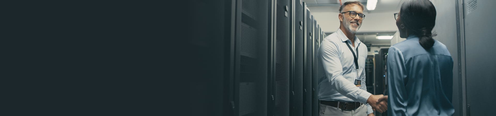 Engineers shaking hands in a data center