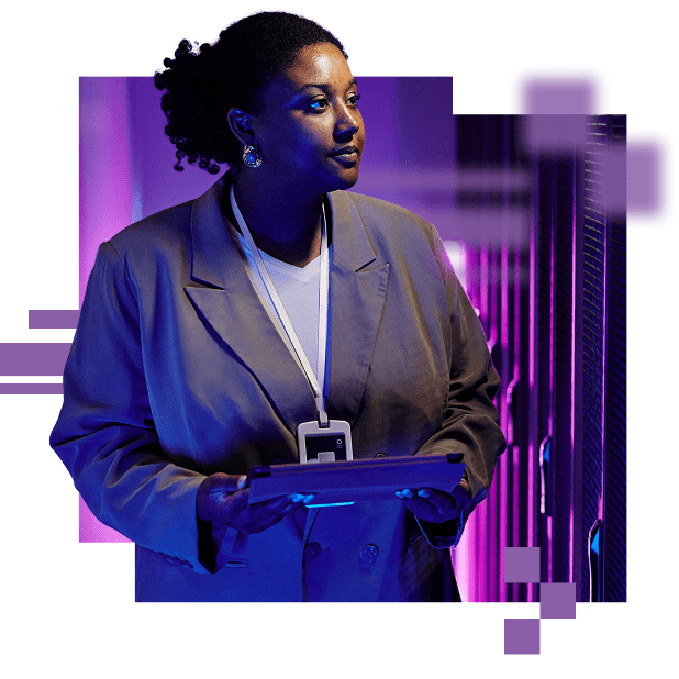 A business woman in a data center holding a tablet, looking to the right inspecting the equipment