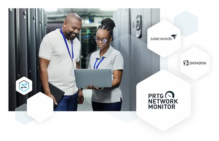 An image of two engineers in a data center looking at a laptop screen and smiling