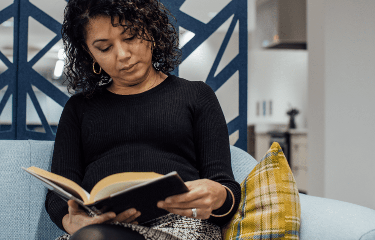 An image of a female employee reading