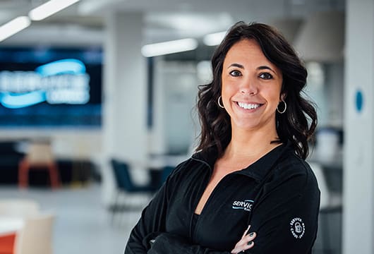 An image of a female employee with a Service Express jacket on smiling