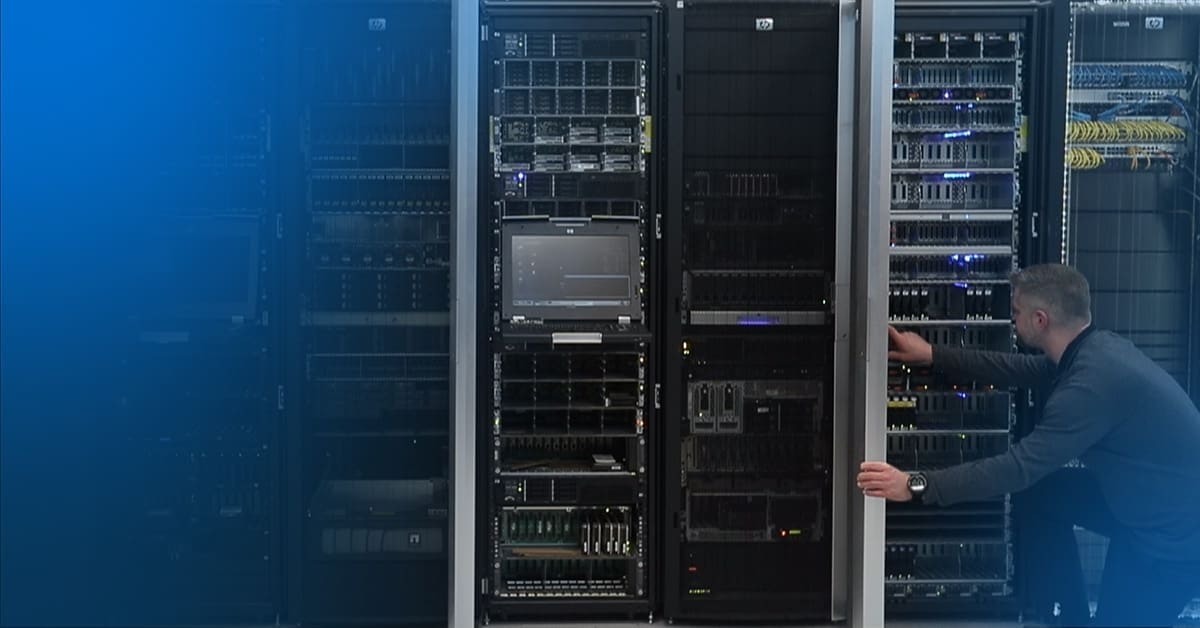 An image of an engineer knelt on one knee inspecting equipment in a data center