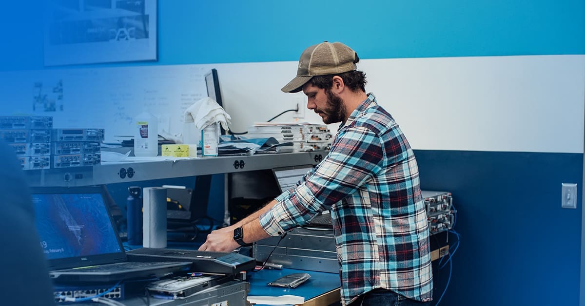 An image of a male engineer at a workstation testing parts