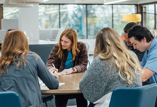 An image of Service Express employees at a table writing