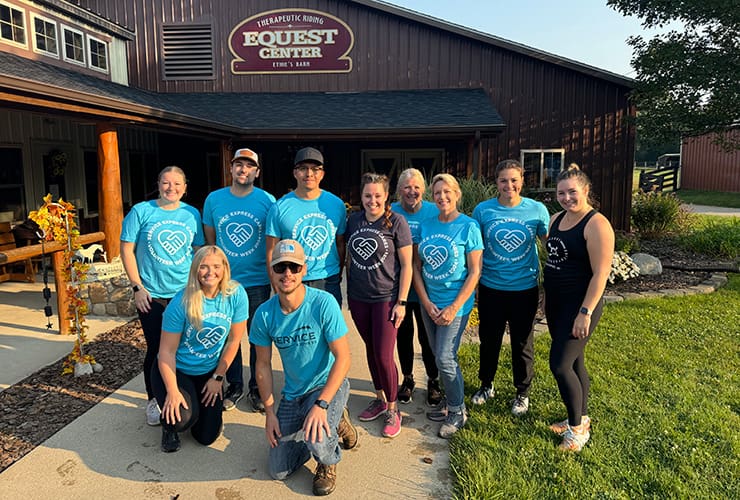 An image of a group of Service Express volunteers at the Equest Center