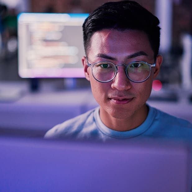 An image of an engineer looking into a computer monitor