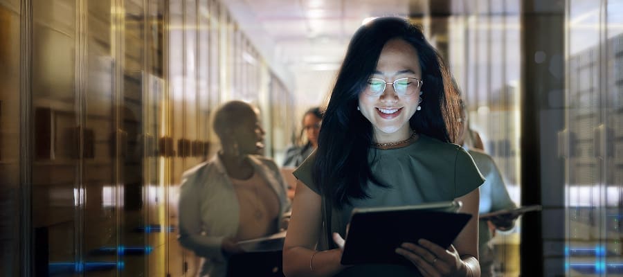 An image of a smiling woman using a tablet